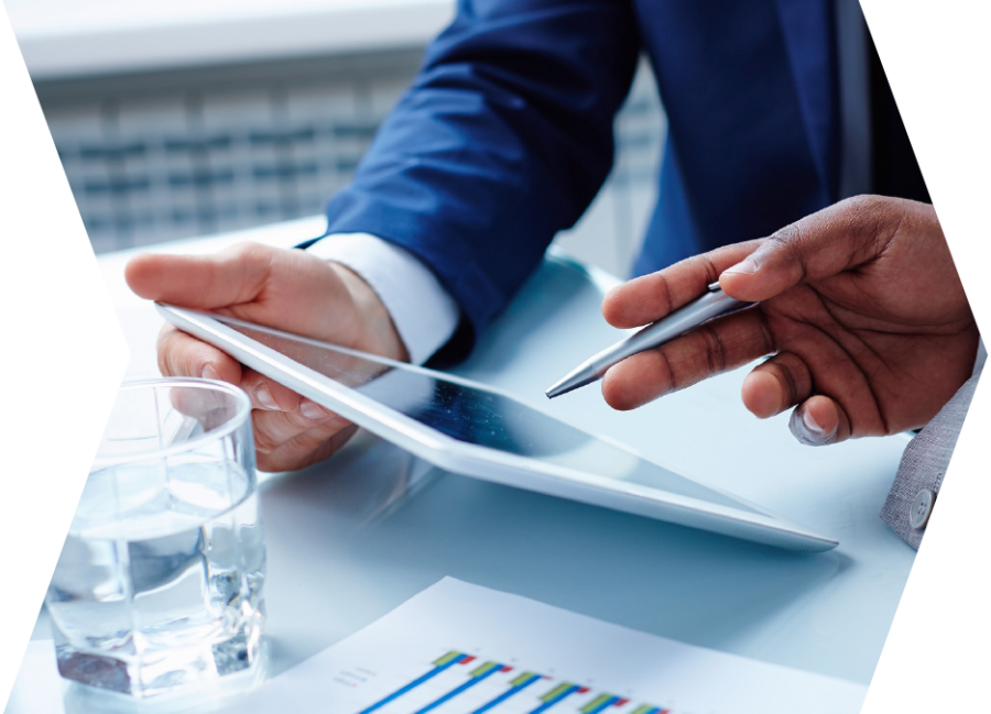 Business men in a meeting consulting at a tablet.