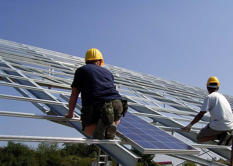 Two workers during the installation of a SunCarrier solar plant.