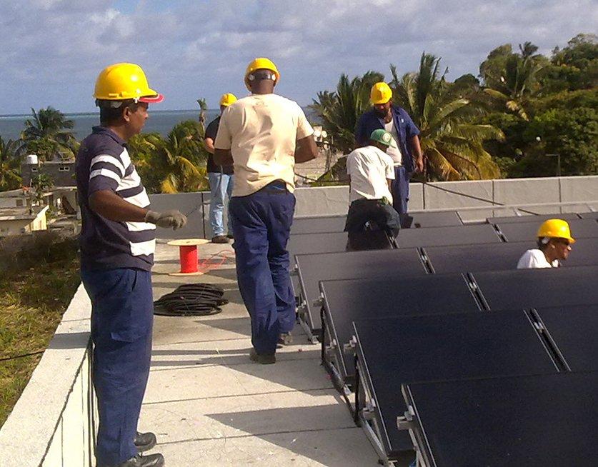 Workers during the installation of rooftop solar system in Mauritius.