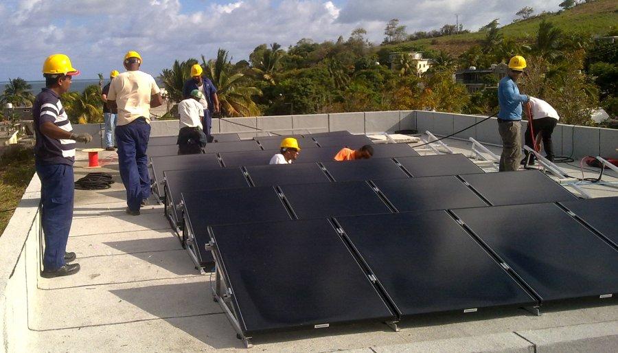 Workers during the installation of rooftop solar system in Mauritius.