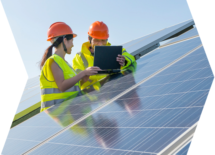 Two engineers with safety vests at a solar installation.