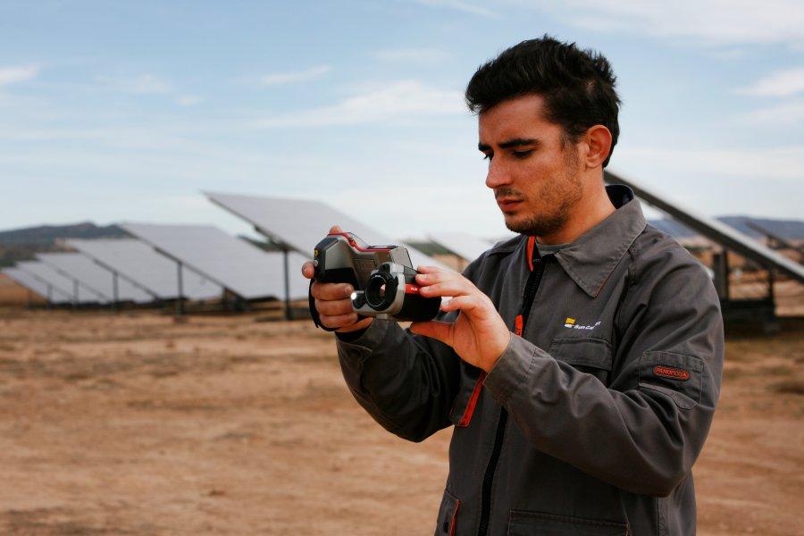 Engineer taking a photo of a solar installation.