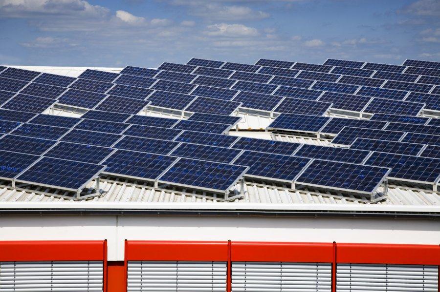 Solar Installation on the rooftop of a white building.