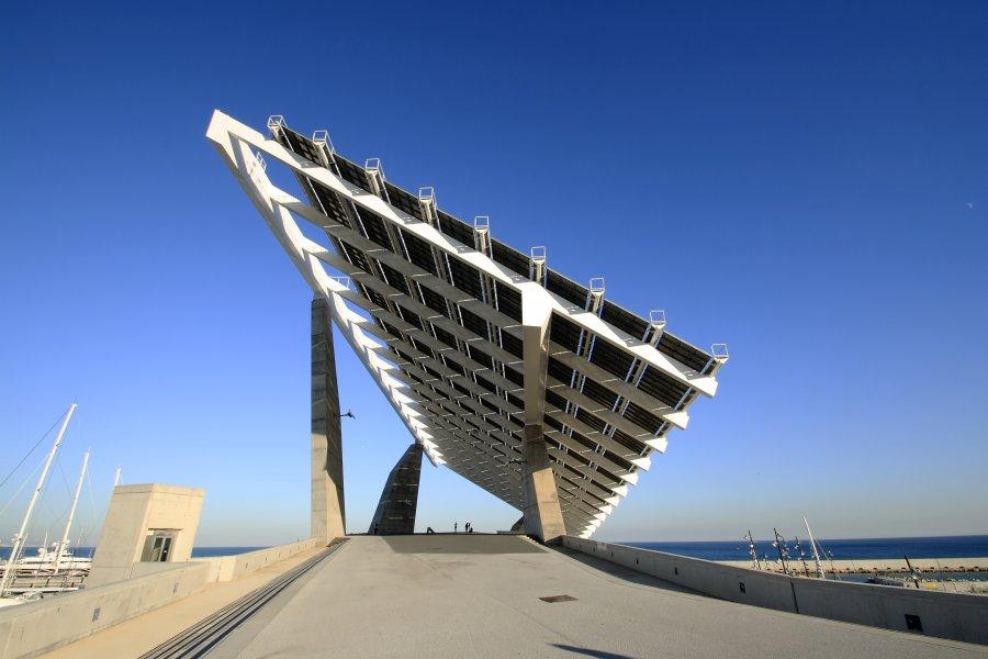 A grid-connected solar installation on a rooftop, near the sea.