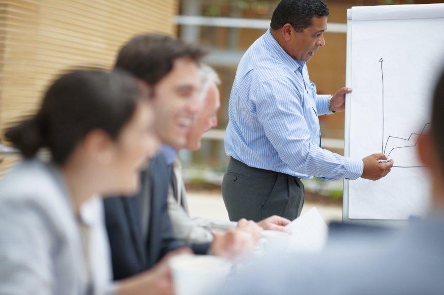 Business man giving his presentation to a group of colleagues during a meeting.