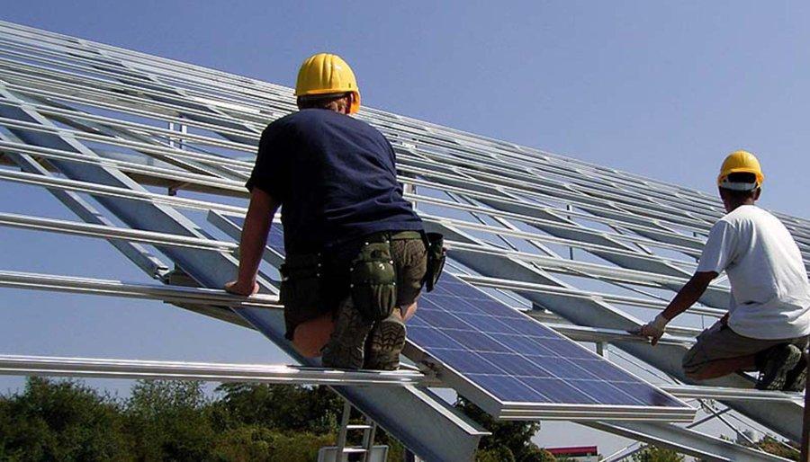 Two workers during the installation of a SunCarrier solar plant.