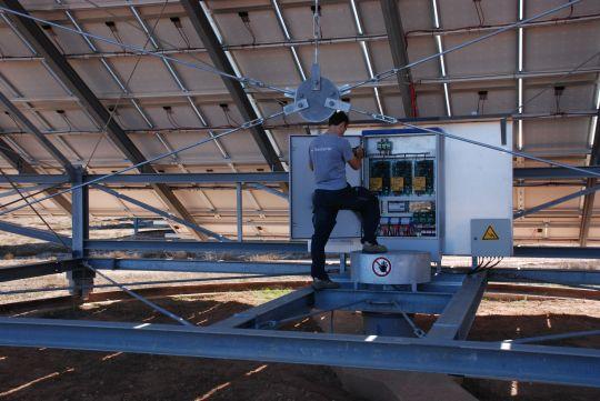 Engineer working at the backside of a solar installation.