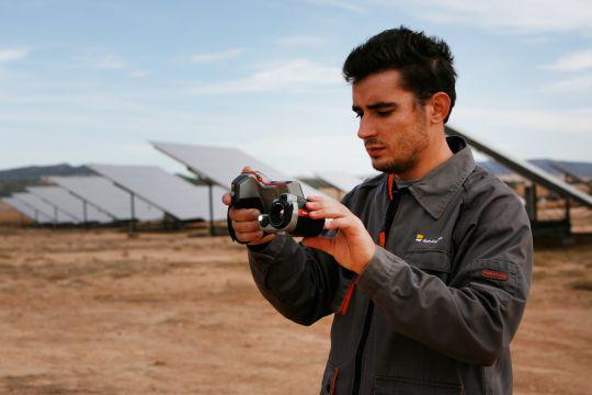 Engineer taking a photo of a solar installation.