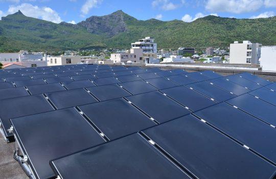 View on a mountain site with solar panels in the foreground.